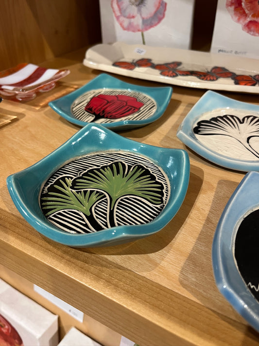 Decorative ceramic plates with artistic designs on a wooden surface